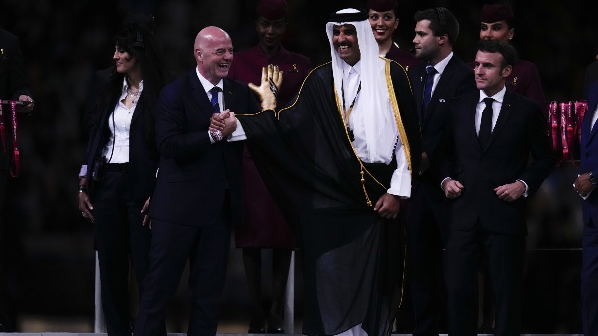(L-R) FIFA President Gianni Infantino, the Emir of Qatar, Sheikh Tamim bin Hamad Al Thani and the French President Emmanuel Macron arrive for the trophy presentation at the end of the World Cup final match between Argentina and France at the Lusail Stadium, Lusail, Qatar, Dec.18, 2022. (AP Photo)