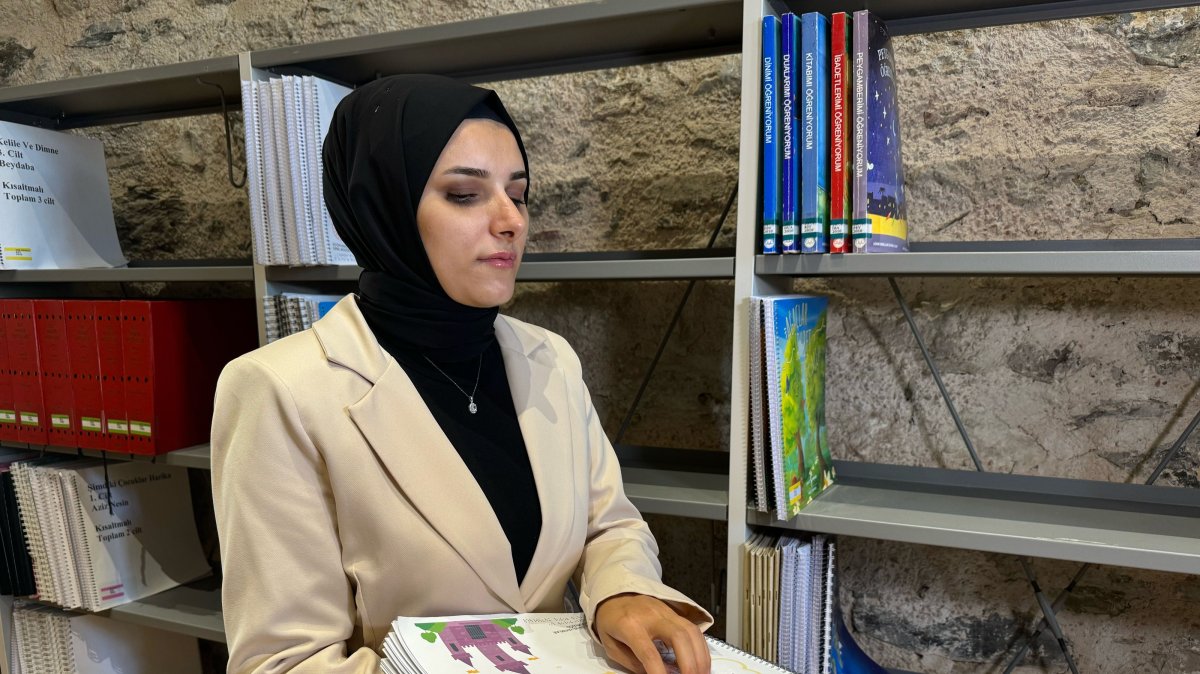 Visually impaired library user Nahide Mutlu is interviewed by Anadolu Agency at the Rami Library, Istanbul, Türkiye, Aug. 14, 2026. (AA Photo)