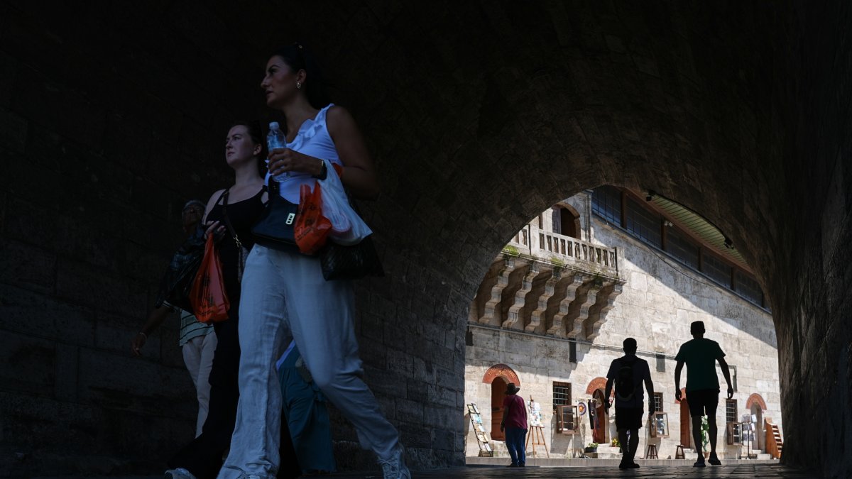 People walk in the famous Eminönü neighborhood in Istanbul, Türkiye, July 28, 2026. (AA Photo)