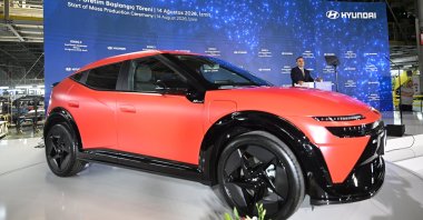 Hyundai's new all-electric IONIQ 3 model is on display as Industry and Technology Minister Mehmet Fatih Kacır delivers a speech at a factory, Kocaeli, Türkiye, Aug. 14, 2026. (AA Photo)