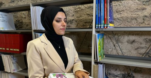 Visually impaired library user Nahide Mutlu is interviewed by Anadolu Agency at the Rami Library, Istanbul, Türkiye, Aug. 14, 2026. (AA Photo)