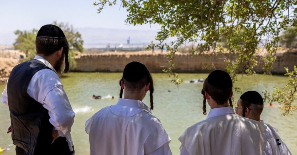 Ultra-Orthodox Jewish people look down at an ancient water reservoir in the Jordan Valley, West Bank, Palestine, Aug. 5, 2026. (Reuters Photo)
