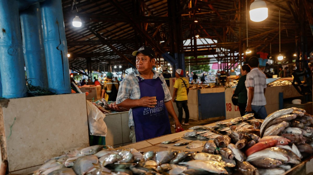 A vendor sells fresh fish at a market as local fishermen are increasingly being pursued by Ecuadorian gangs to move drugs and for their skills in navigating the Pacific waters along Ecuador's coast, which has become a hub for the international smuggling of narcotics over the last half-decade, Manta, Ecuador, June 4, 2026. (Reuters Photo)