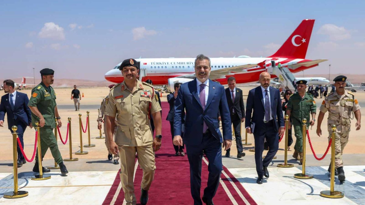 Saddam Haftar (L), deputy commander-in-chief of the Libyan National Army, and Foreign Minister Hakan Fidan walk on the red carpet at the welcoming ceremony for Fidan, Benghazi, Libya, Aug. 12, 2026. (DHA Photo)