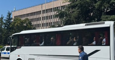 Suspects wait in a bus outside a courthouse, Ankara, Türkiye, Aug. 16, 2026. (AA Photo)