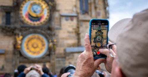 An undated view of an elderly male tourist taking picture of the famous Prague astronomical clock on the Old Town Square, Prague, Czechia. (Shutterstock Photo)