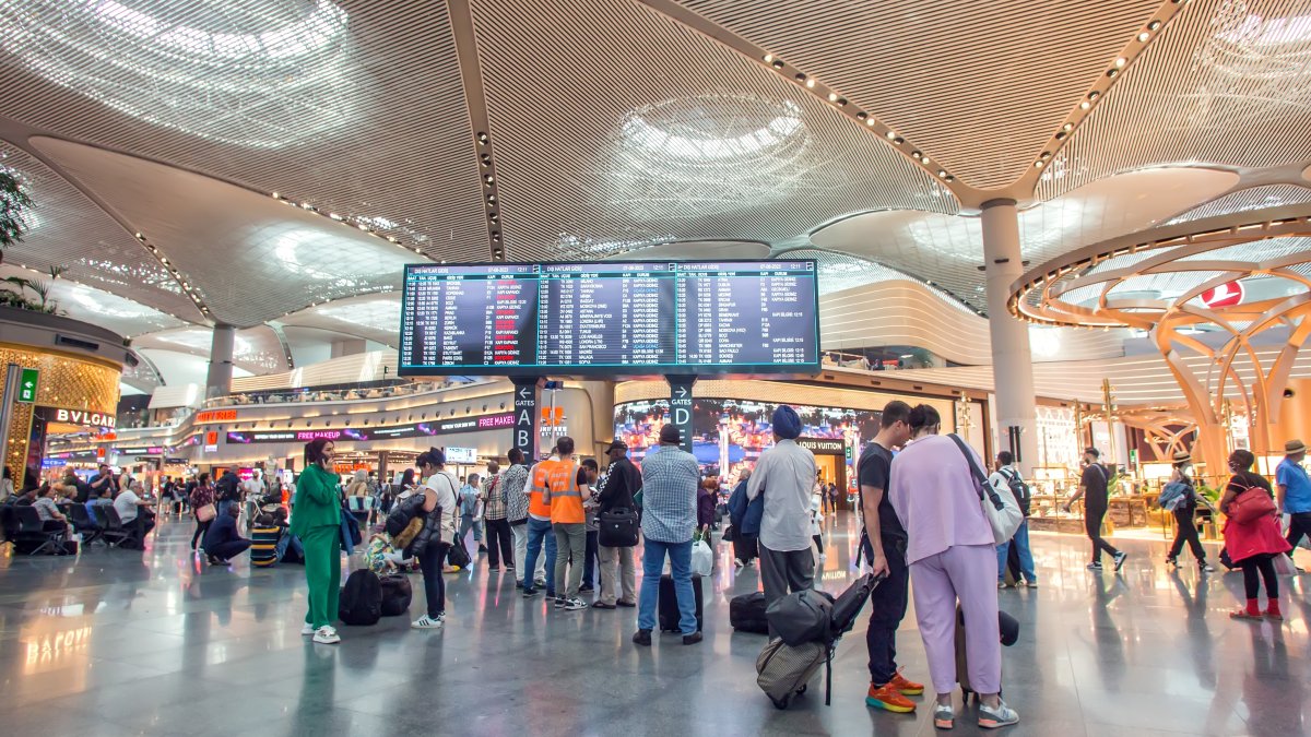 Passengers are seen near the flight timetable at Istanbul Airport, Istanbul, Türkiye, June 7, 2026. (Shutterstock Photo)