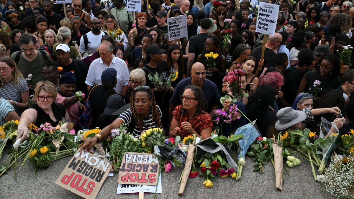 People lay flowers down at the end of a vigil by Stand Up To Racism to remember former Cambridge professor Jason Arday, who died aged 41 on Friday after resigning amid plagiarism allegations he denied, at Trafalgar Square in London, U.K., Aug. 17, 2026. (Reuters Photo)