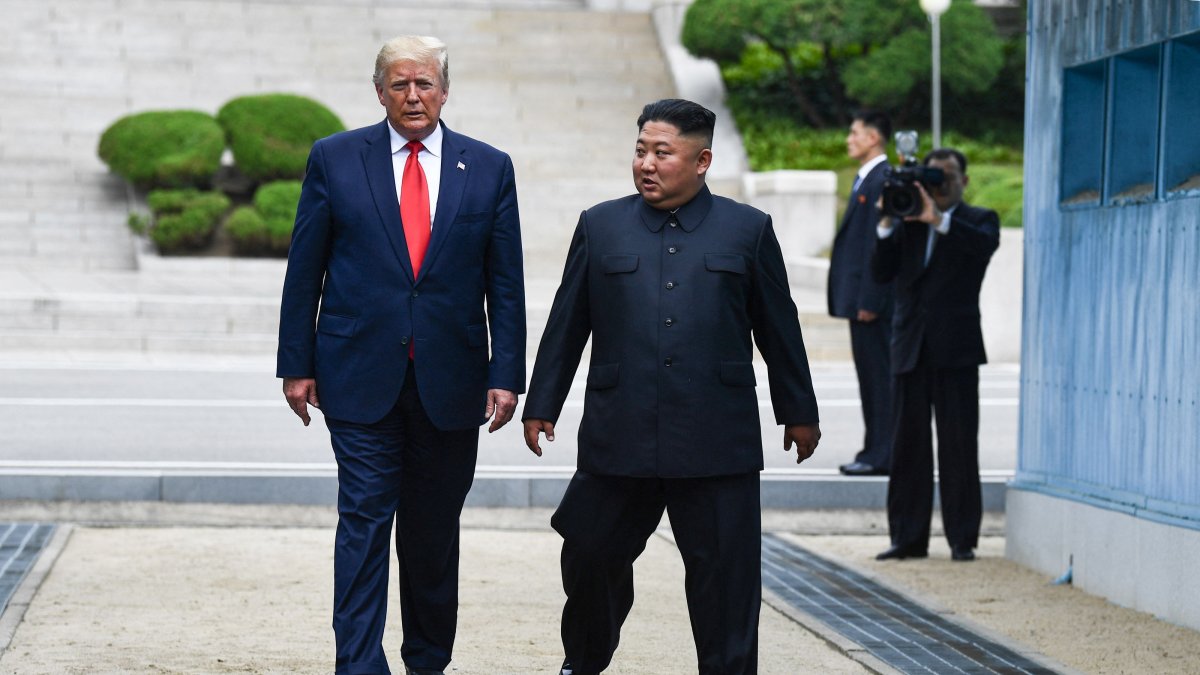 North Korea's leader Kim Jong Un and U.S. President Donald Trump cross south of the Military Demarcation Line that divides North and South Korea, after Trump briefly stepped over to the northern side, in the Joint Security Area (JSA) of Panmunjom in the Demilitarized zone (DMZ) on June 30, 2019. (AFP File Photo)