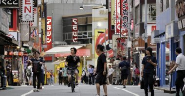 People walk through a shopping street in the Shinjuku commercial, business and entertainment district, Tokyo, Japan, Aug. 17, 2026. (EPA Photo)