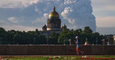 Smoke rises following a Ukrainian drone attack on a warehouse for online retailer Wildberries, with St. Isaac's Cathedral seen in the foreground, St. Petersburg, Russia, July 24, 2026. (AP Photo)