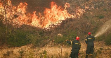 Firemen work to extinguish a wildfire near the village of Siviri, Greece, Aug. 13, 2026. (AFP Photo)