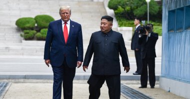 North Korea's leader Kim Jong Un and U.S. President Donald Trump cross south of the Military Demarcation Line that divides North and South Korea, after Trump briefly stepped over to the northern side, in the Joint Security Area (JSA) of Panmunjom in the Demilitarized zone (DMZ) on June 30, 2019. (AFP File Photo)