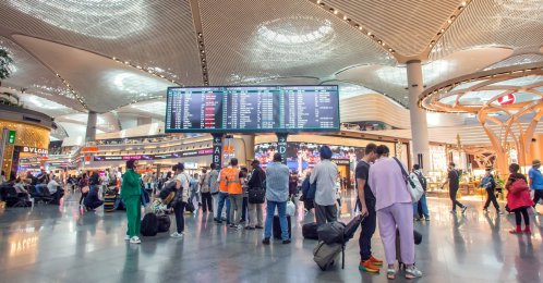 Passengers are seen near the flight timetable at Istanbul Airport, Istanbul, Türkiye, June 7, 2026. (Shutterstock Photo)