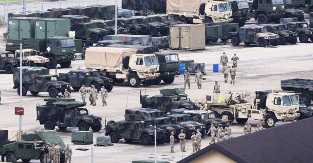 U.S. soldiers are seen near military vehicles at Camp Humphreys in Pyeongtaek, South Korea, Aug. 17, 2026. (AFP Photo)