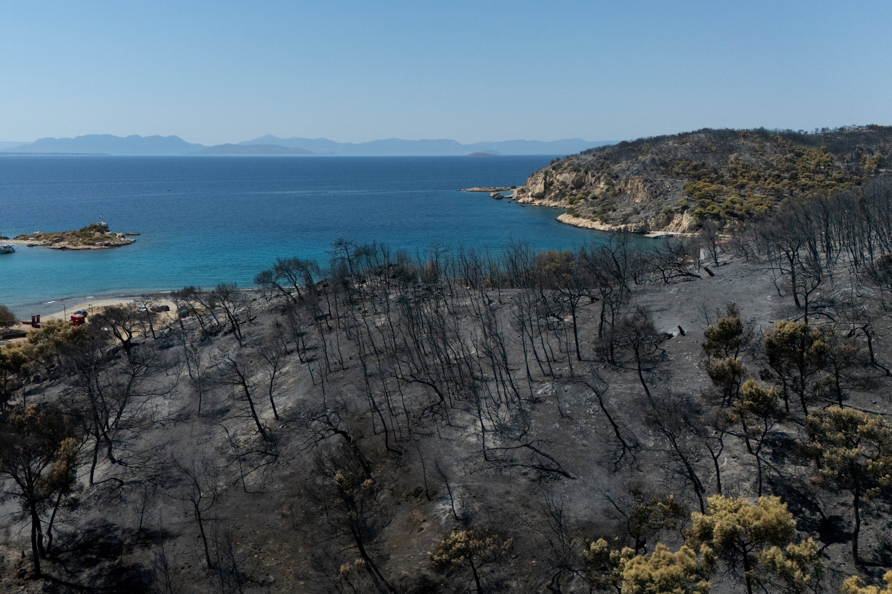 A drone view of a burned forest area following a wildfire in the Peristeria area, Salamina island, near Athens, Greece, Aug. 17, 2026. (Reuters Photo)