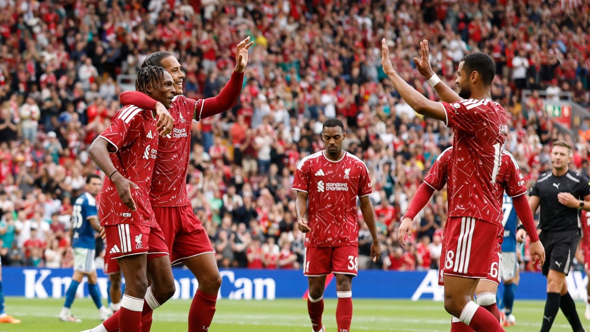 Liverpool's Jeremy Jacquet celebrates scoring their first goal with teammates Virgil van Dijk and Cody Gakpo during the pre-season friendly match against Como at Anfield, Liverpool, U.K., Aug. 16, 2026. (Reuters Photo)