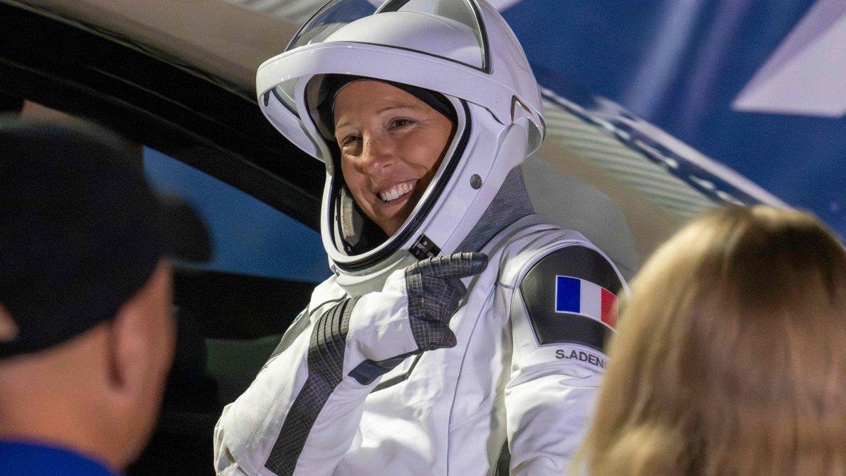 ESA (European Space Agency) astronaut Sophie Adenot points to the French flag on her shoulder before traveling to the SpaceX Falcon 9 rocket with the company's Dragon spacecraft at Space Launch Complex 40 for the Crew-12 mission at Cape Canaveral Space Force Station, Florida, U.S., Feb. 13, 2026. (AFP Photo)