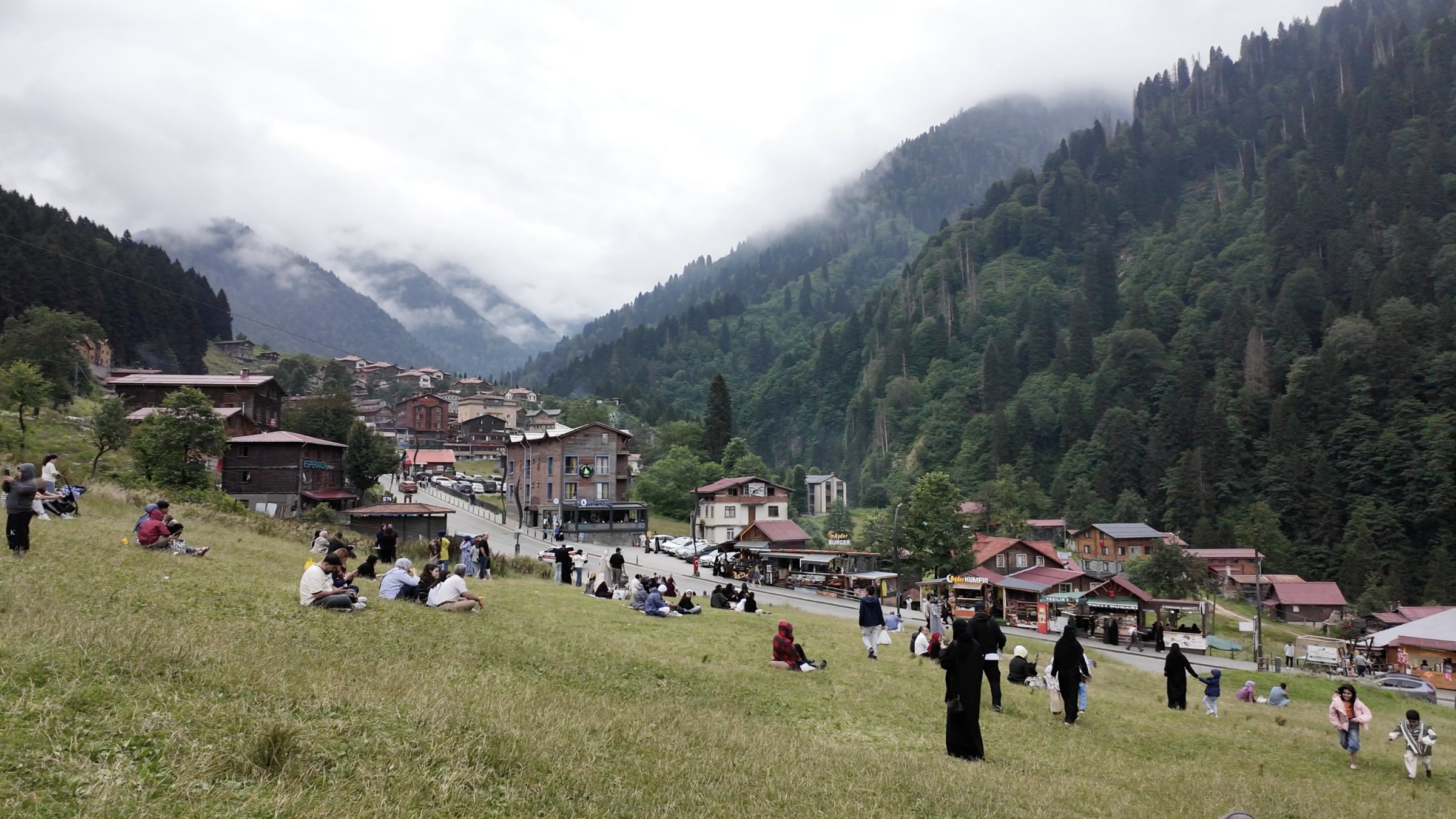 Visitors gather on the slopes overlooking Ayder Plateau, a popular highland destination known for its mountain settlements and dramatic forested landscape, Rize, Türkiye, July 30, 2026. (Photo by Buğra Çakmak)