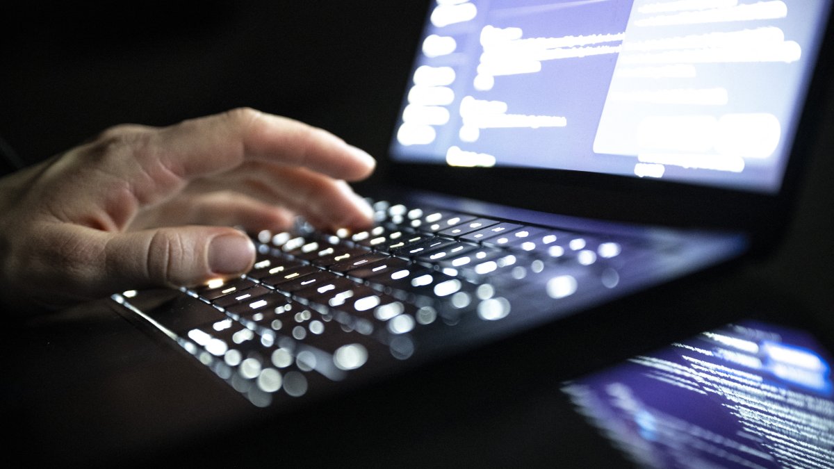 A person types with his fingers on an illuminated laptop keyboard, Berlin, Dec. 14, 2025. (AFP File Photo)