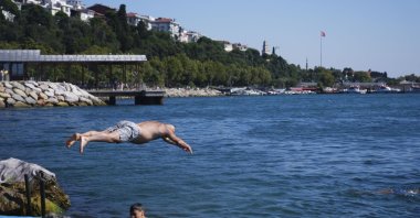 People seeking relief from hot weather swim in the sea along Üsküdar's coast, Istanbul, Türkiye, Aug. 14, 2026. (AA Photo)
