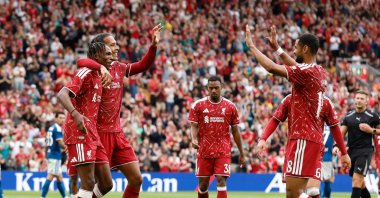 Liverpool's Jeremy Jacquet celebrates scoring their first goal with teammates Virgil van Dijk and Cody Gakpo during the pre-season friendly match against Como at Anfield, Liverpool, U.K., Aug. 16, 2026. (Reuters Photo)