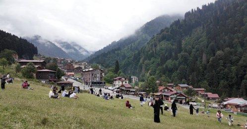 Visitors gather on the slopes overlooking Ayder Plateau, a popular highland destination known for its mountain settlements and dramatic forested landscape, Rize, Türkiye, July 30, 2026. (Photo by Buğra Çakmak)