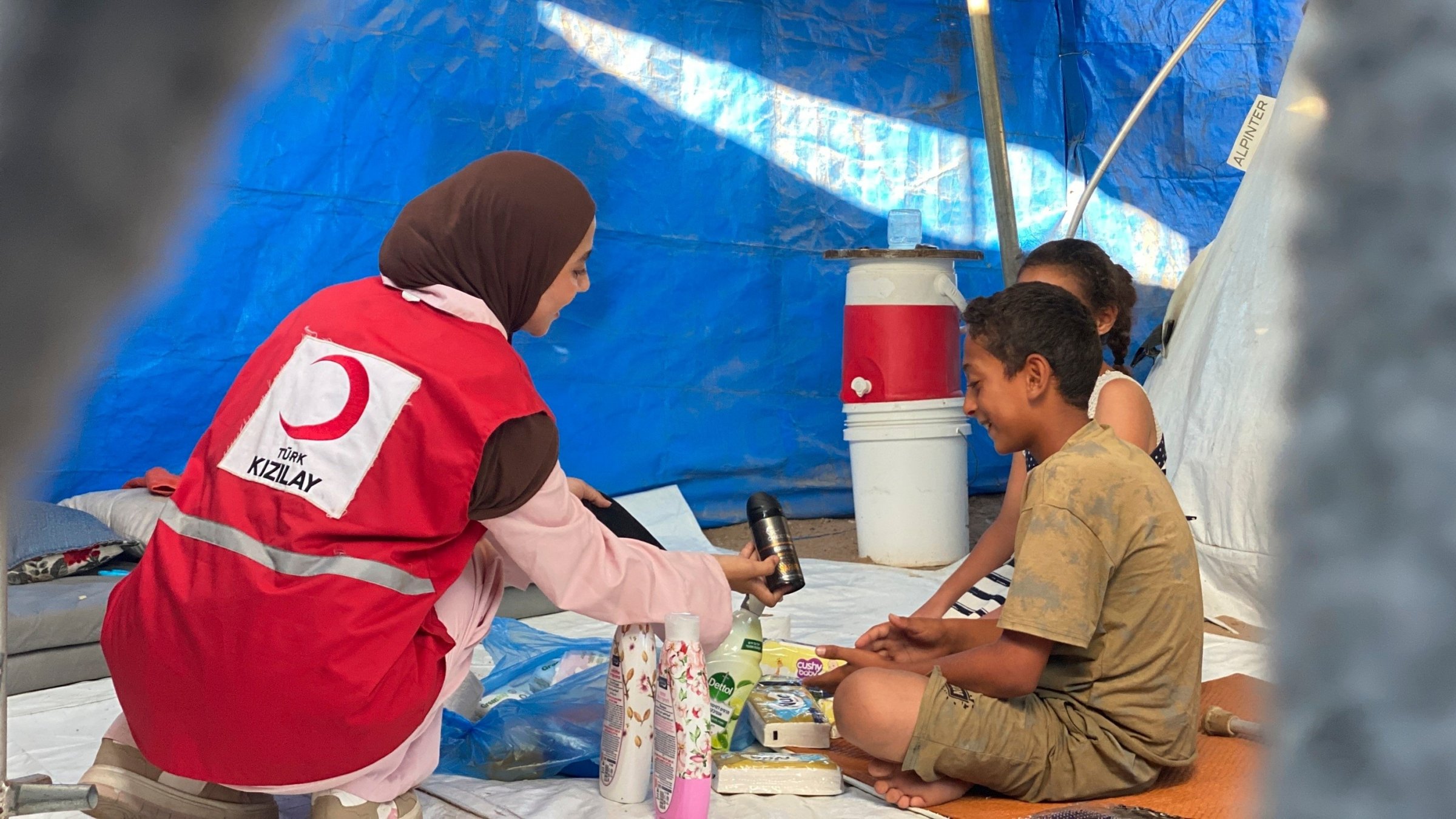 The Turkish Red Crescent (Kızılay) distributes drinking water and hygiene kits daily in Gaza, where outbreaks of infectious diseases are on the rise due to poor hygiene conditions and high temperatures, Gaza, Palestine, Aug. 9, 2026. (İHA Photo)