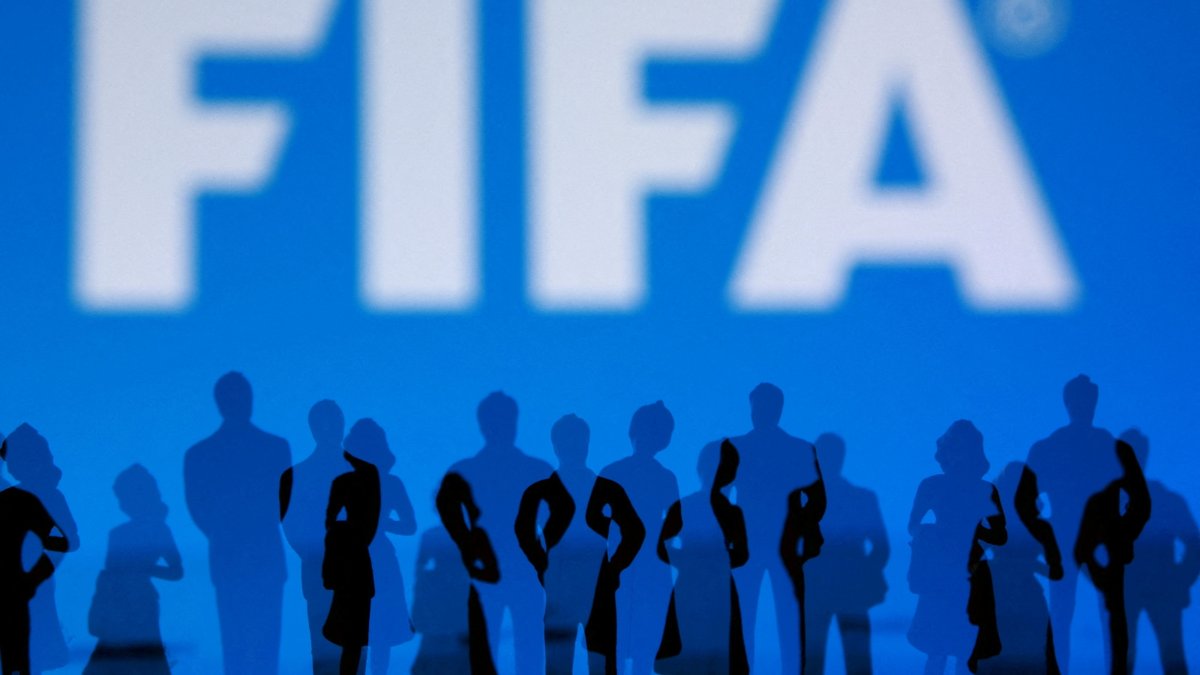 The FIFA logo and silhouettes of people are seen in this illustration, July 30, 2026. (Reuters Photo)