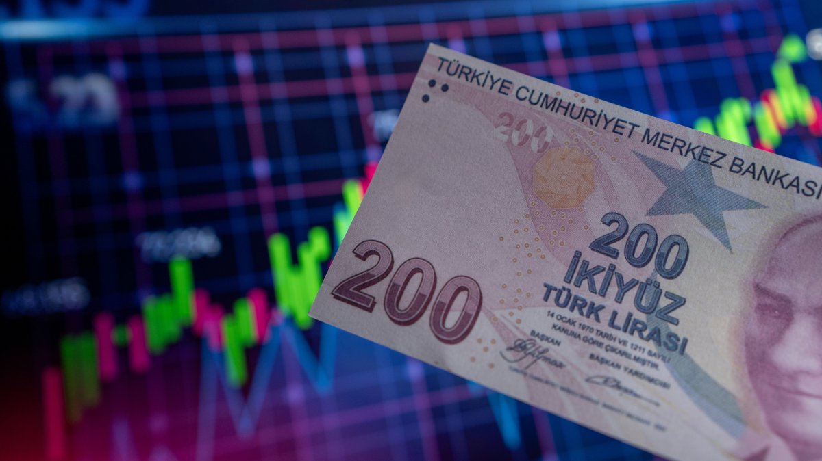In this photo illustration, a 200 Turkish lira banknote is displayed in front of an economic chart, Türkiye, July 24, 2023. (Reuters Photo)