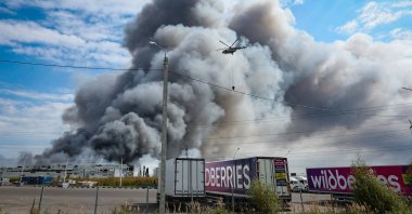 A firefighting helicopter flies above a burning Wildberries facility following a reported Ukrainian drone strike at the Koledino Industrial Park near Podolsk, Moscow Region, Russia, Aug. 16, 2026. (EPA Photo)