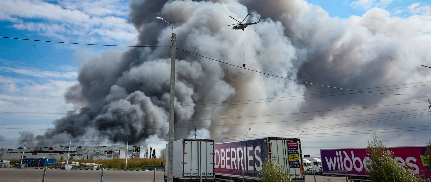 A firefighting helicopter flies above a burning Wildberries facility following a reported Ukrainian drone strike at the Koledino Industrial Park near Podolsk, Moscow Region, Russia, Aug. 16, 2026. (EPA Photo)