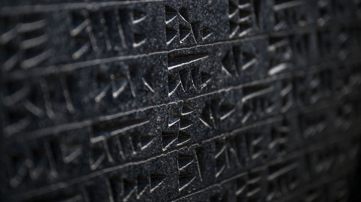 A tablet unearthed with a surface displaying circles, dots, triangles and square or rectangular motifs formed using scratching and pressing techniques, July 22, 2026. (AFP Photo)