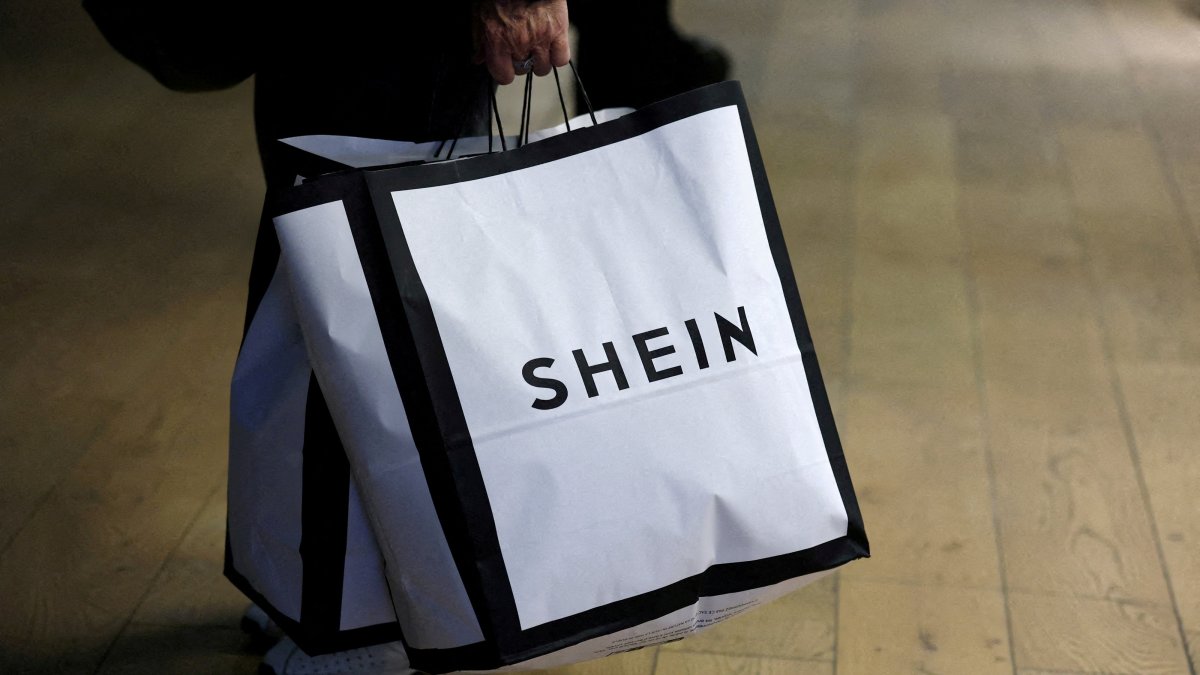 A customer holds shopping bags with a Shein logo in the first physical space of online fast-fashion retailer Shein on the day of its opening inside the Le BHV Marais department store, the Bazar de l'Hotel de Ville, in Paris, France, Nov. 5, 2025. (Reuters Photo)