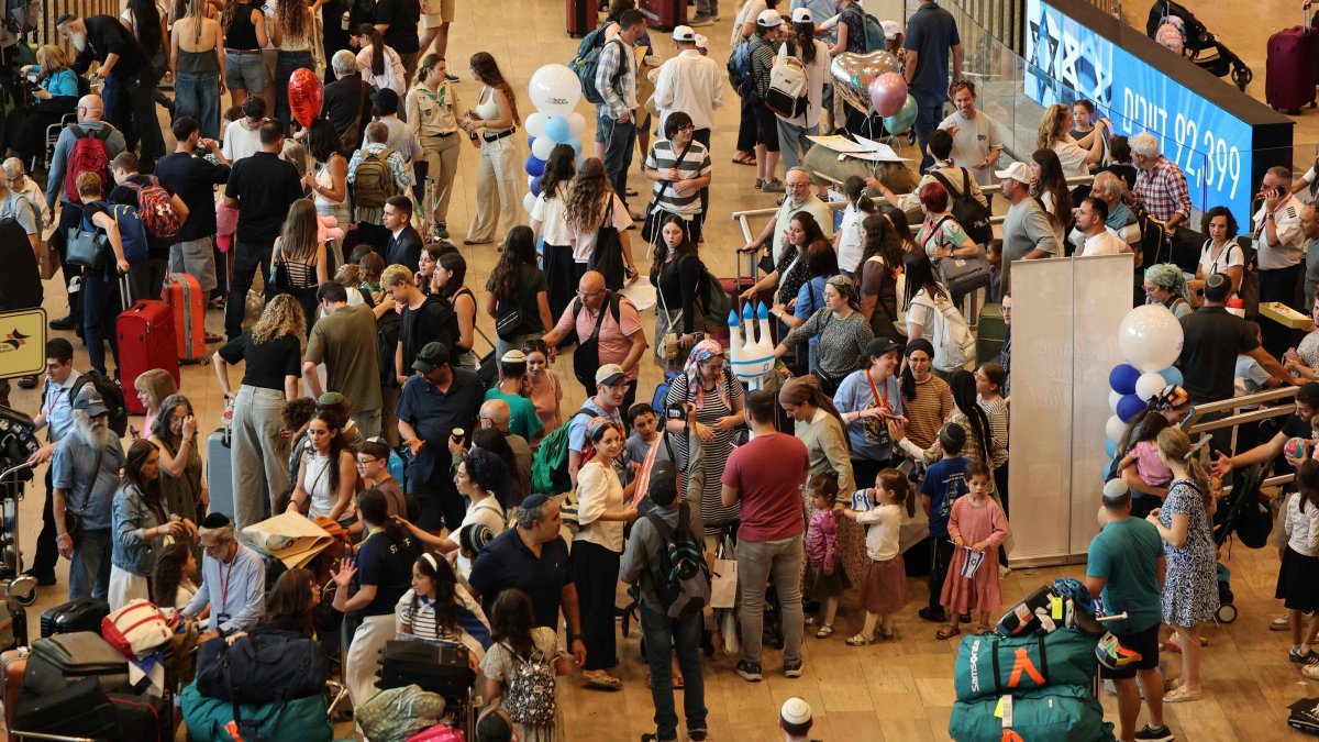 Passengers wait with their luggage amid disruptions caused by a surprise staff strike at Ben Gurion Airport in Lod, near Tel Aviv, Israel, Aug. 20, 2026. (AFP Photo)