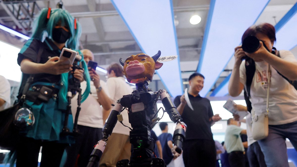 People take images of a small robot designed to resemble a character from the Chinese animated movie Niu Lai at the 2026 World Robot Conference in Beijing, China, Aug. 19, 2026. (Reuters Photo)