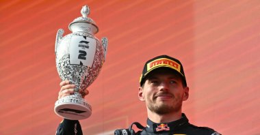 Second-placed Red Bull Racing's Dutch driver Max Verstappen celebrates with the trophy on the podium after the Formula One Hungarian Grand Prix at the Hungaroring racetrack, Mogyorod, Hungary, July 26, 2026. (AFP Photo)