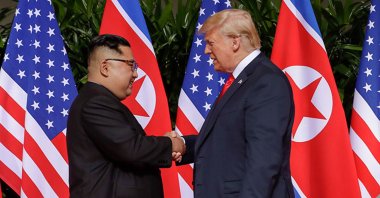This file photo shows U.S. President Donald Trump (R) shaking hands with North Korean leader Kim Jong Un on Sentosa Island in Singapore, June 12, 2018. (DHA Photo)