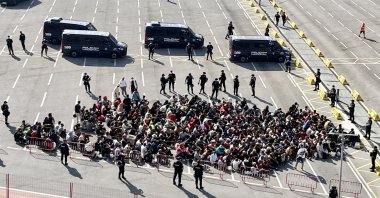 Migrants gather as they wait to be transferred to a shelter in Ceuta, Spain, Aug. 20, 2026. (EPA Photo)