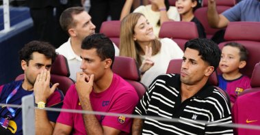 Barcelona's Rodri (C) and Joao Cancelo (R) watch from the stands during the Joan Gamper Trophy match against Al Ahly at the Camp Nou, Barcelona, Spain, Aug. 19, 2026. (AA Photo)