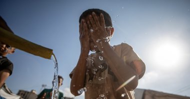 A Palestinian displaced boy washes his face at a displacement camp in central Gaza City, Palestine, Aug. 20, 2026. (EPA Photo)
