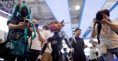 People take images of a small robot designed to resemble a character from the Chinese animated movie Niu Lai at the 2026 World Robot Conference in Beijing, China, Aug. 19, 2026. (Reuters Photo)