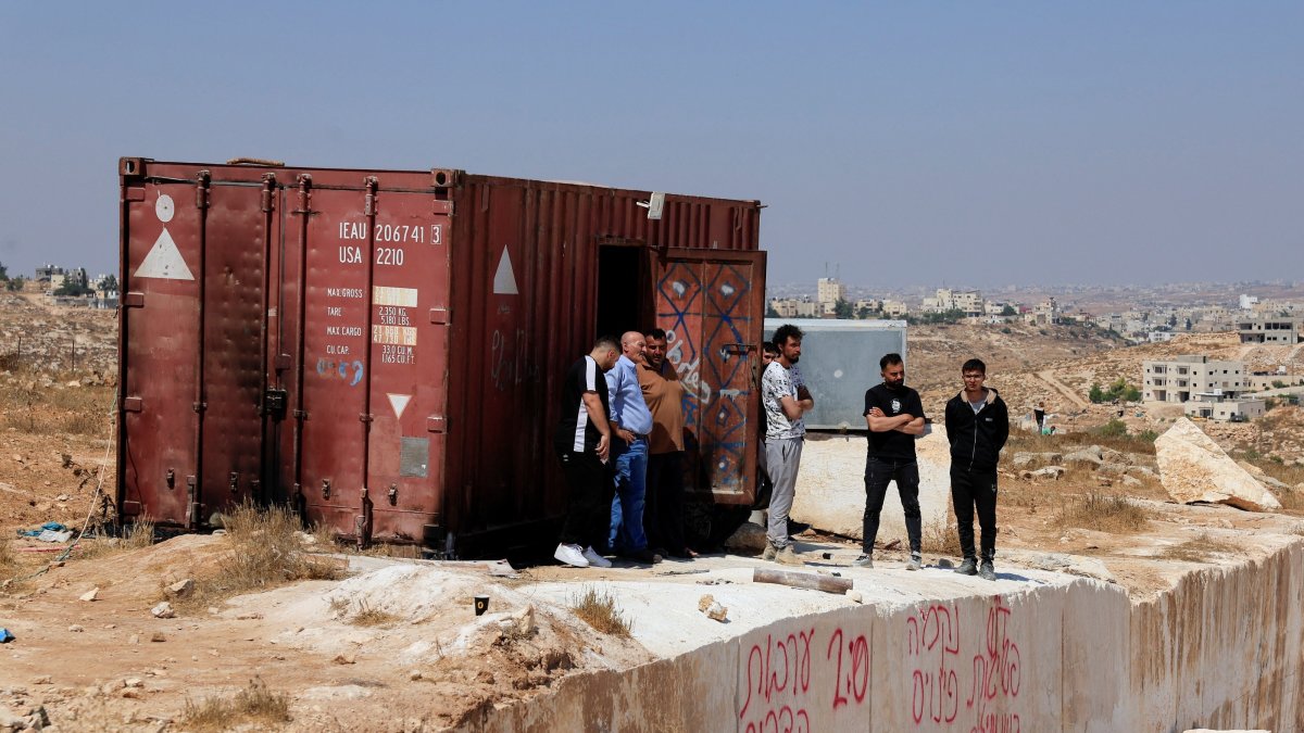 Palestinians inspect the damage after militant Israeli settlers set fire to stone quarry machinery, according to residents, near Hebron, West Bank, Palestine, Aug. 21, 2026. (Reuters Photo)