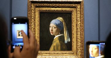 Visitors take pictures of Johannes Vermeer’s painting "Girl with a Pearl Earring" during the press preview of the exhibition "Vermeer’s Girl with a Pearl Earring: Dutch masterpieces of the 17th century" at the Nakanoshima Museum of Art, Osaka, Japan, Aug. 20, 2026. (EPA Photo)