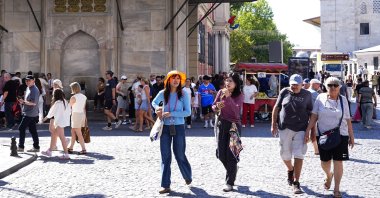 Tourists walk in the historic Eminönü district in Istanbul, Türkiye, July 29, 2026. (AA Photo)