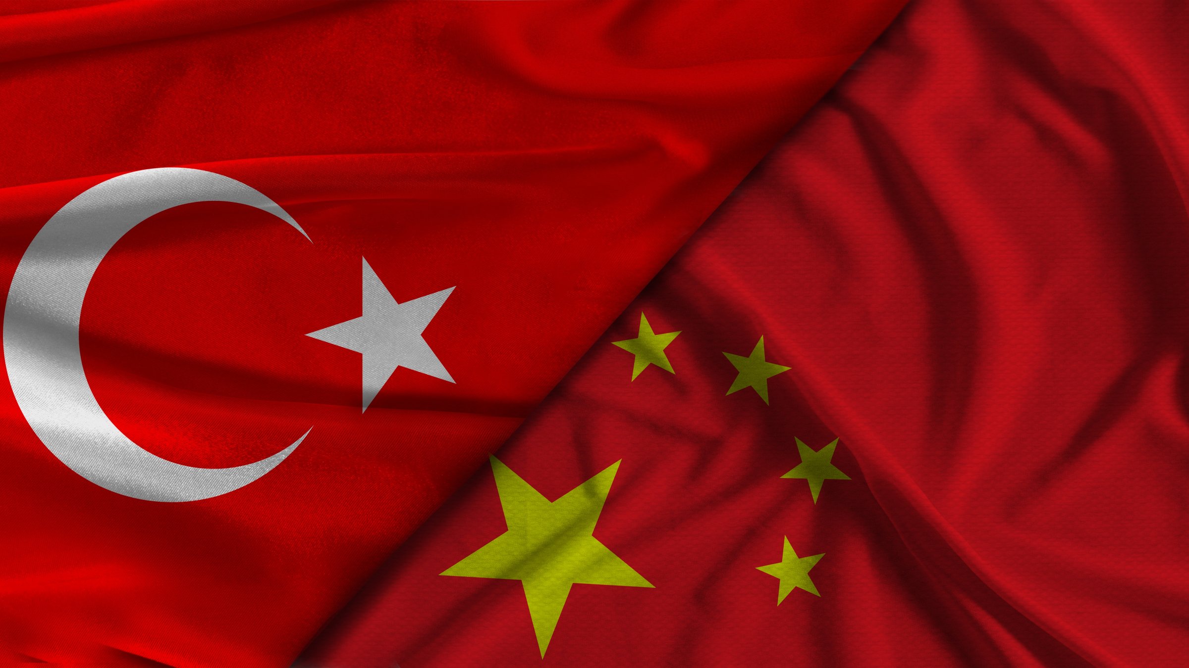 The flags of Türkiye (L) and China (R) are pictured side by side. (Shutterstock Photo)