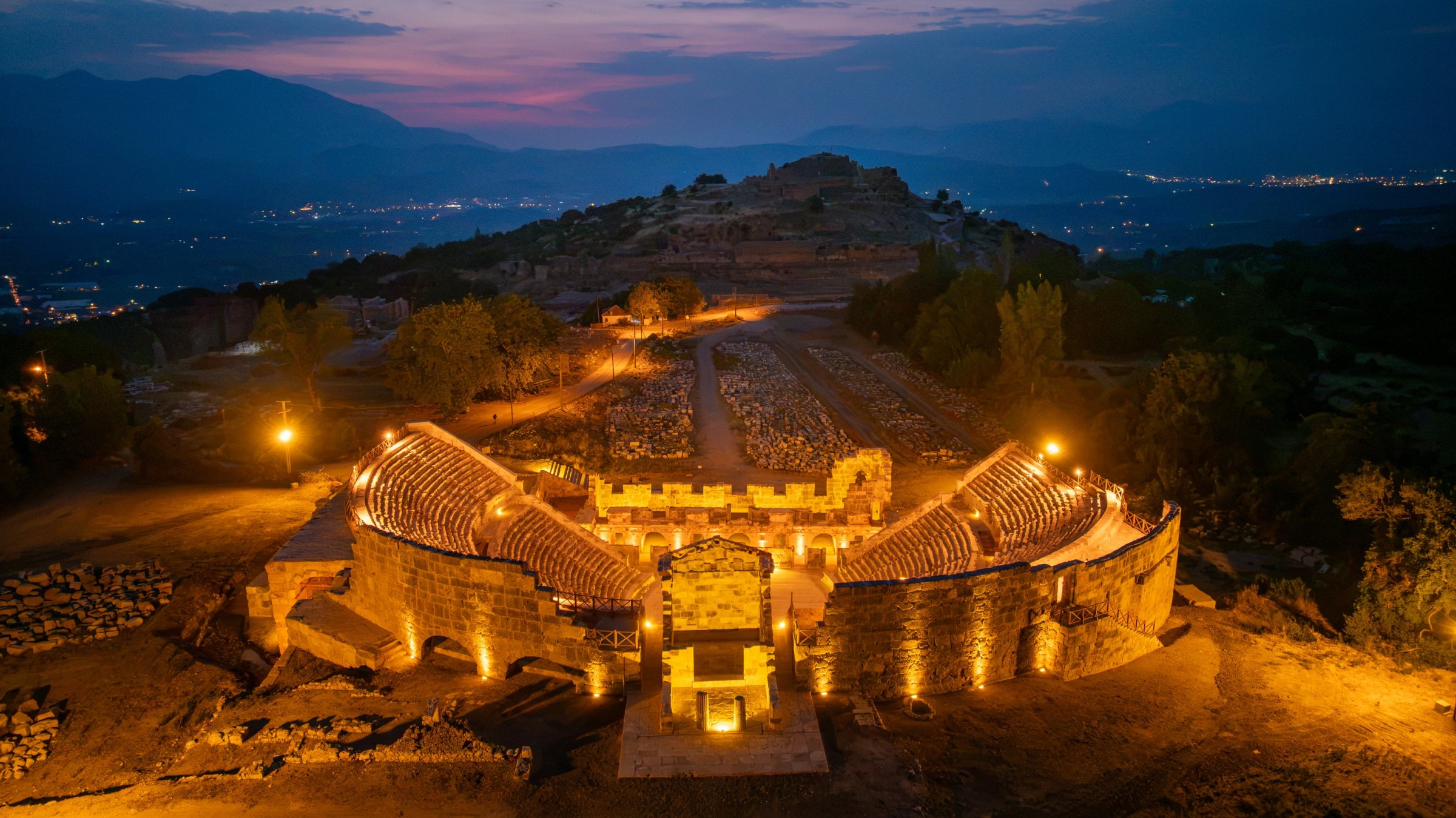 An aerial view of the restored ancient theater at Tlos illuminated by a solar energy system, Muğla, Türkiye, Aug. 22, 2026. (AA Photo)