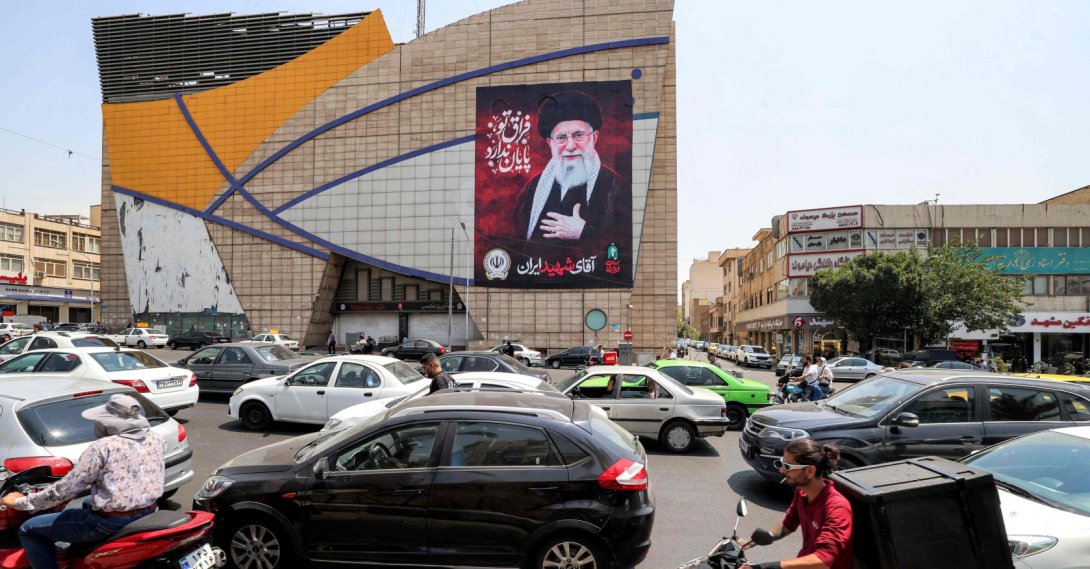Motorists drive vehicles past a billboard depicting Iran's late supreme leader Ali Khamenei along a street, central Tehran, Iran, Aug. 8, 2026. (AFP Photo)