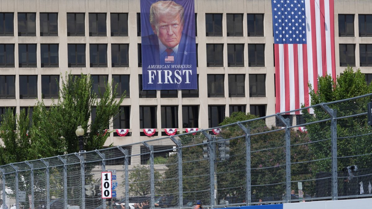 A U.S. flag and a poster of U.S. President Donald Trump as drivers take part in the Freedom 250 Grand Prix IndyCar Series race in Washington, D.C., U.S., Aug. 23, 2026. (Reuters Photo)