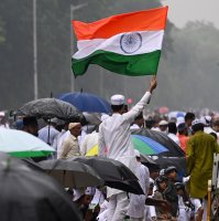 A Muslim devotee waves the national flag of India after the Eid al-Fitr prayer in Kolkata, India, March 21, 2026. (Getty Images Photo)